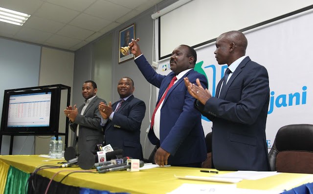 Officials ring the bell to mark the launch of mobile share trading at the Dar es Salaam Stock Exchange
